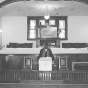 Black and white photograph of Rev. Alphonse Reff standing in the pulpit at St. Mark’s African Methodist Episcopal Church, Duluth, July 8, 1975.