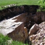 Color image of a pipe quarry pit, Pipestone National Monument, 2009. Photograph by the National Park Service.