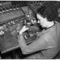 Woman operating a drill press