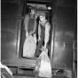 Railway Mail Service clerks load mail bags onto a Great Northern Railway Post Office car at the St. Paul Union Depot.