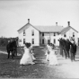 Black and white photograph of students performing a drill on the grounds of a Native American boarding school, c.1890s.