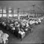 photograph of a room full of women at sewing machines