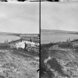 Black and white photograph of a view of La Pointe with Bayfield in the distance, 1875.