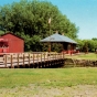 Postcard of the turntable, depot, engine house, and Grand Trunk Western caboose at End-o-Line Railroad Park and Museum, ca. 1980.