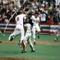 Twins relief pitcher Jeff Reardon is mobbed by catcher Tim Laudner and third baseman Gary Gaetti after the final out in the deciding Game Seven.