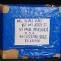 Color image of a corrugated cardboard box used as a packing carton by Blia Cha Thao and family—Hmong refugees who moved from Thailand to Minnesota in 1993.