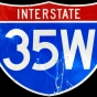 Highway identification sign for Interstate 35W. The sign stood on Bridge 9340, which carried I-35W over the Mississippi River in Minneapolis. The sign stood on the bridge at the time of its collapse on August 1, 2007. Its surface is heavily scratched, and this damage may be a direct result of the collapse.