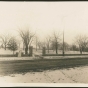 The stone fence added to the Woodbury House property by the Caswell family in 1911. Both the vehicle and pedestrian gates are visible, opening onto an unpaved Ferry Street. Photographer and exact date unknown. Anoka County Historical Society, Object ID# 2074.1.5. Used with the permission of Anoka County Historical Society.