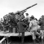 Black and white photograph of soldiers of the newly formed 215th Coast Artillery Regiment at Camp Ripley, 1940.