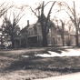 Photograph of the Ticknor House taken in 1972. Interior renovations in 1938 had turned the house into three separate apartments, and divided up and sold much of the Ticknor property that formerly took up the whole block. No further extensive renovations were made until after the house was sold out of the Ticknor family in 1977. Photographer unknown. Anoka County Historical Society, object ID# 3000.3.66.