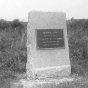 Photograph of a rectangular stone monument with metal plaque honoring the Fourth Minnesota regiment