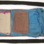 A "soldier's housewife" sewing kit made from a strip of leather with a twill-like finish and lined with silk.