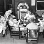 Black and white photograph of after-hours relaxation in Camp Ripley’s Enlisted Service Club, 1958.  