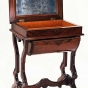 Color image of a Walnut sewing table used by Harriet Bishop. Created in 1850.