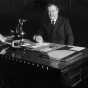 Black and white photograph of Lawrence S. Donaldson at his desk, c.1920. Photograph by C.J. Hibbard. 