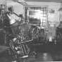 Black and white photograph of a printing machine in the office of the Waconia Patriot. Date and photographer unknown.