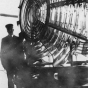 Black and white photograph of Franklin J. Covell by the Split Rock Lighthouse lens.