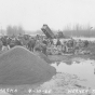 Black and white photograph of the rebuilding dikes in Chaska during flood of 1965. Photographed by Werner Studio, April 10, 1965.