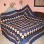 Color image of Anna and Lena Ewert posing with a quilt they made and donated to the Tabor College Carson Center quilt auction, 2009.