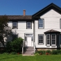 Color image of the Banfill Tavern, now Banfill-Locke Center for the Arts, 2013. Photographed by Wikimedia Commons user McGhiever. 