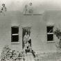 Black and white photograph of a brick house under construction in Meire Grove c.1890.