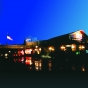 Color digital print of the exterior of Chanhassen Dinner Theatres at night.