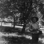 Black and white photograph of Lewis Merrill in the apple orchard on the Merrill's property, 1898.