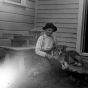 Black and white photograph of Lewis H. Merrill and his dog Mack at the backdoor of the Harrington-Merrill House, 1900.