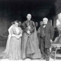 Black and white photograph of Mary T. and James J. Hill with Cardinal Vannutelli, a Papal delegate, on the Hill House veranda, 1910.