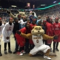 The Lady Warriors (a basketball team representing Cedar-Riverside, a neighborhood in Minneapolis) pose with the University of Minnesota mascot Goldy Gopher and Minnesota Lynx mascot Prowl during project recognition at a Minnesota Lynx WNBA game, August 30, 2015.