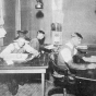 Black and white photograph of the depot agent, engineer, and telegraph operator working inside the Westbrook Depot, 1916.