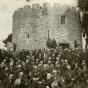 Black and white photograph of a reunion of First Minnesota Volunteer Infantry Regiment, posed in front of Round Tower, 1902.