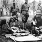 Black and white photograph of Candidates looking over United States Army kit at the Officers’ Training Camp, Fort Snelling, 1917. 