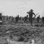 Black and white photograph of officer candidates advancing during military maneuvers, 1917. 