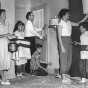 Black and white photograph of the Gerlach family at their home during a civil defense drill,1956.