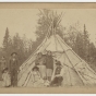 Group of Ojibwe in front of a wigwam at Grand Portage