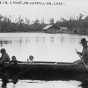 Black and white photograph of an Ojibwe family in canoe on Lake Vermilion, ca. 1905. 