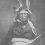 Black and white photograph of the Ho-Chunk leader Baptiste Lasallier wearing a mix of American Indian and Euro-American clothing, c.1855.