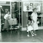 Employee Dick Liecting pushing a grocery cart for two shoppers at the Red Owl Store, Southdale Mall, Edina. 