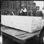 People standing beside stone used for the Capitol