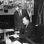 Black and white photograph of Governor Elmer Benson signing a bill with Grange Master William B. Pearson looking on, 1963. Photographed by Eugene Debs Becker. 