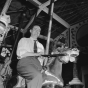 Black and white photograph of Hubert Humphrey riding the merry-go-round at the Minnesota State Fair, 1947. 