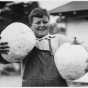 Black and white photograph of boy holding squash entered in the 1934 State Fair.