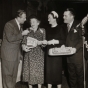 Black and white photograph from the Grand National Bake-Off at the Waldorf Astoria, New York, 1950. Left to right: Art Linkletter, contestant, Duchess of Windsor (the former Wallis Simpson), Philip Pillsbury.