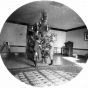 Black and white photograph of Gertrude and Walter J. Hill standing in front of a Christmas tree at the James J. Hill house, 240 Summit, St. Paul, 1891.