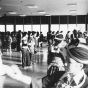 Black and white photograph of ttendees at the 1981 Hmong New Year, held in St. Paul’s Highland Junior-Senior High School, participate in pov pob, a ball-toss courtship ritual. Photographed by Marlin Heise on December 19, 1981.