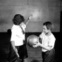 Black and white photograph of two girls playing basketball at Phyllis Wheatley House, ca. 1925.