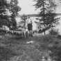 Black and white photograph of a man with string of fish caught in Itasca Lake, c.1915.