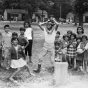 Black and white photograph of Mexican American migrant farm-worker children playing, ca. 1960. 