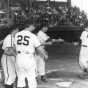 Chick Simunek is greeted at home plate after hitting a grand slam during a June 20, 1951 game at Rox Stadium, 1951.